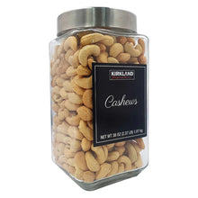 Glass canister of cashews with metal lid and centered front label