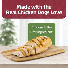 Sliced chicken breast pieces on a wooden cutting board.