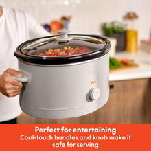 bella slow cooker with glass lid and white body, control knob visible