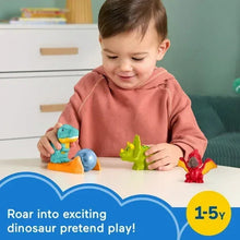Toddler playing with dinosaur figures on an orange boulder base