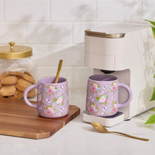 Purple stoneware mug pair with pink floral design and curved handles