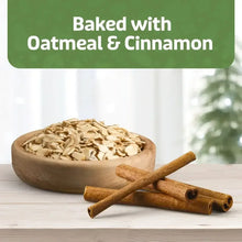 Oatmeal and cinnamon ingredients on a wooden bowl with cinnamon sticks.