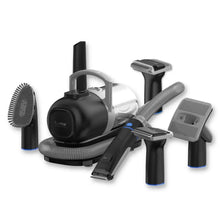 Pet grooming vacuum kit with black handheld vacuum unit and multiple brush attachments