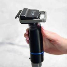 Handheld pet grooming vacuum with comb nozzle, dark body and blue accent