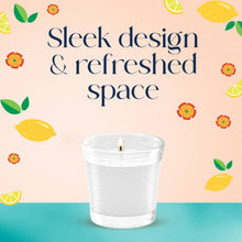 White jar candle with lit wick, straight-sided clear container, fresh scent theme
