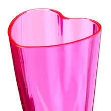 Pink plastic heart-shaped champagne glass rim, close-up