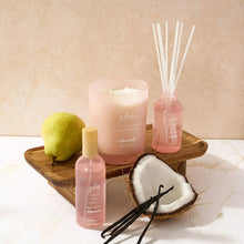 Glow scented spa candle jar with matching mini bottle and reed diffuser on a tray