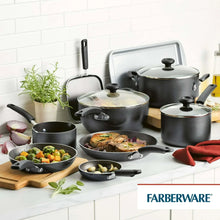 Nonstick cookware set on countertop with covered pots and frying pans.