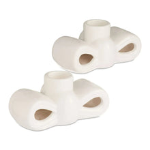 White stoneware bow taper candle holders with cup opening and oval cutouts
