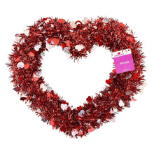 Red tinsel heart wreath with glitter heart discs and hanging tag on right