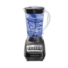 Black smoothie blender with clear jar containing colored frozen mixture