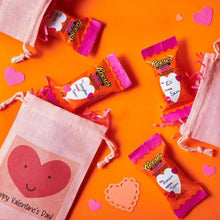 Assorted peanut butter hearts snack-size milk chocolate candies in small purple wrappers