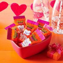 Peanut butter hearts snack-size candies spilling from a red Valentine-style gift box