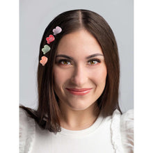 Pastel heart claw hair clips on dark hair, worn on the side for a cute look