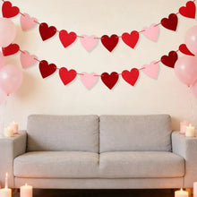 Red and pink felt heart garland banner with hearts strung above sofa