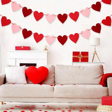 Red and pink felt heart garland banner above a couch