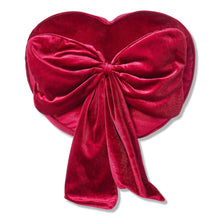 Heart-shaped red decorative pillow with ruched center bow and long hanging tails.