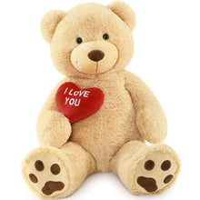 Giant teddy bear plush in light brown with a red “I Love You” heart on its chest