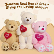 Three giant teddy bear plushes with red “I Love You” heart badges