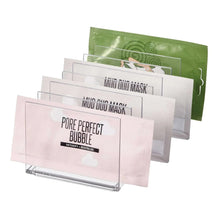 Clear acrylic cosmetic organizer holding stacked face mask packets