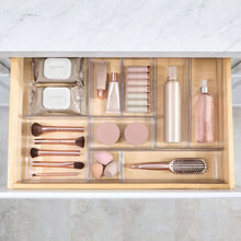 Clear drawer organizer set with 9 sections holding lipsticks, bottles, and makeup pads