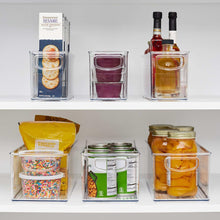 Clear deep storage bins set with handle fronts holding pantry items and jars
