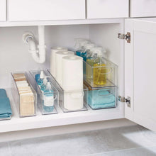 Clear deep storage bins set neatly arranged inside a cabinet shelf