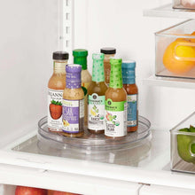 Clear turntable lazy Susan organizer tray with circular ridges and multiple bottles