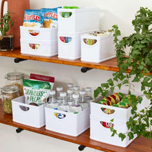 White stacking kitchen storage bins with oval cutout handles on a shelf
