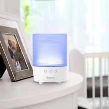 Blue-lit candle Bluetooth speaker with white base and front control buttons