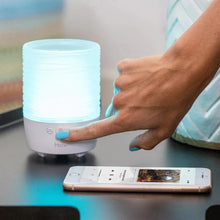 White candle Bluetooth speaker with blue glow and front touch control panel