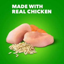 Hand holding sliced chicken and rice grains for dog wet food recipe