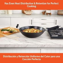 Preseasoned cast iron wok with dual loop handles and black cooking interior