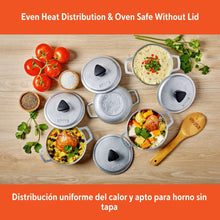 Mini caldero set, gray cast aluminum pots with lids, arranged for serving