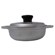 Cast aluminum caldero with lid, gray pot with black knob and side handles.