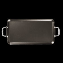 Rectangular griddle pan with two side handles, dark surface with raised edges