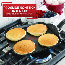 Grey nonstick griddle with black handle, showing four pancakes in cooking surface