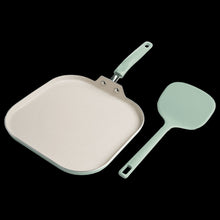 Square nonstick griddle pan with mint handle, light interior, and metal hanging loop.