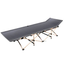 Folding camping cot with tapered head section and dark fabric sleeping surface