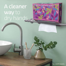 Kleenex hand towels box dispensing white paper towels near a sink