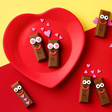 Heart-shaped red serving tray with KitKat mini milk chocolate bars and heart decorations
