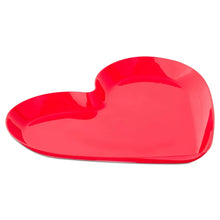 Red heart-shaped serving platter with glossy surface and curved sides