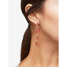 Red and gold LOVE linear drop earrings on model's ear