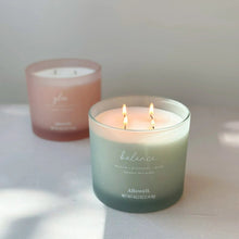 Balance spa jar candle, pale blue jar with two burning wicks in the foreground