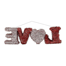 Tinsel hanging decoration spelling “LOVE” in red and silver, heart-shaped center