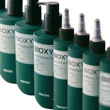 BIOXYL scalp revitalizing shampoo bottles with black pumps, teal-green