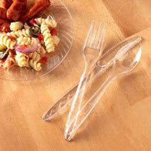 Clear plastic fork and spoon utensils, arranged for serving