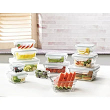 Glass food storage containers set with clear lids, filled portions on display.