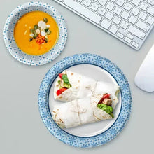 Paper bowl with blue snowflake rim and plate, holding food items on dishware