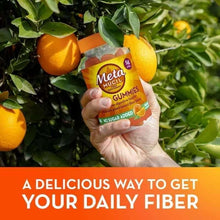 Metamucil Fiber Gummies bottle in hand, no sugar added, orange flavor
